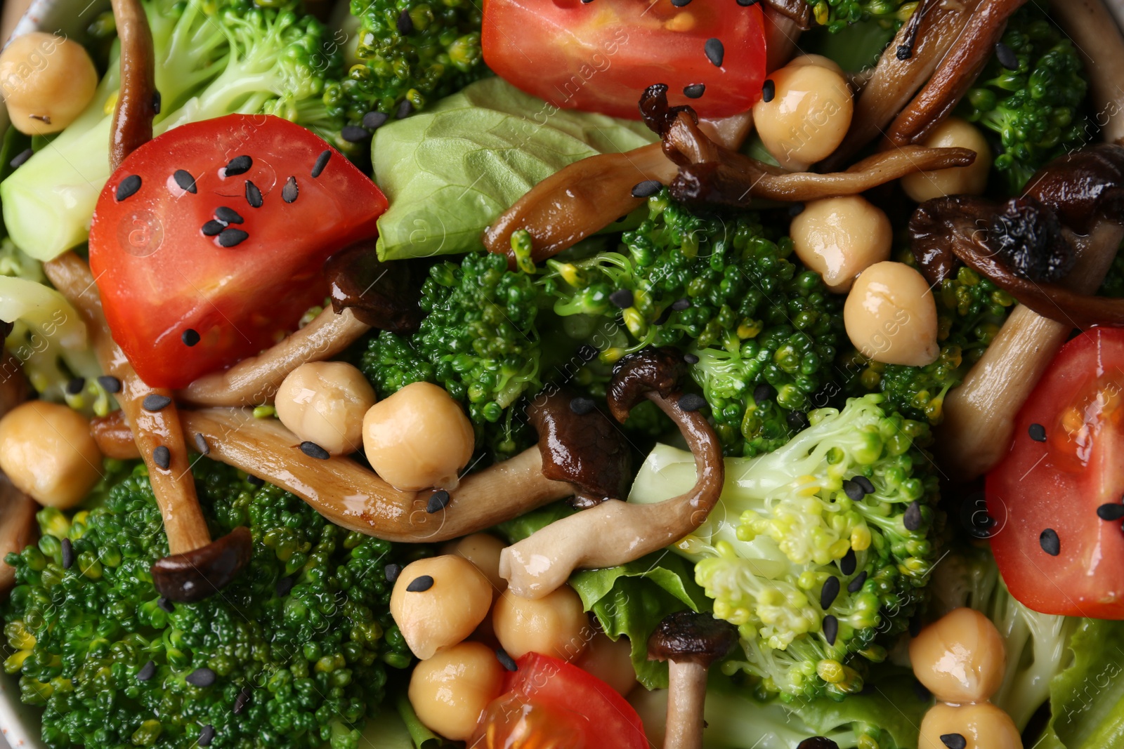 Delicious salad with shimeji mushrooms, chickpeas, tomatoes and broccoli as background, top view Photo of Delicious salad with shimeji mushrooms, chickpeas, tomatoes and broccoli as background, top view