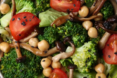 Photo of Delicious salad with shimeji mushrooms, chickpeas, tomatoes and broccoli as background, top view