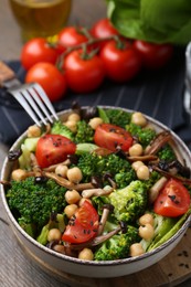 Photo of Delicious salad with shimeji mushrooms served on table, closeup