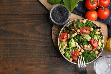 Photo of Delicious salad with shimeji mushrooms on wooden table, flat lay. Space for text