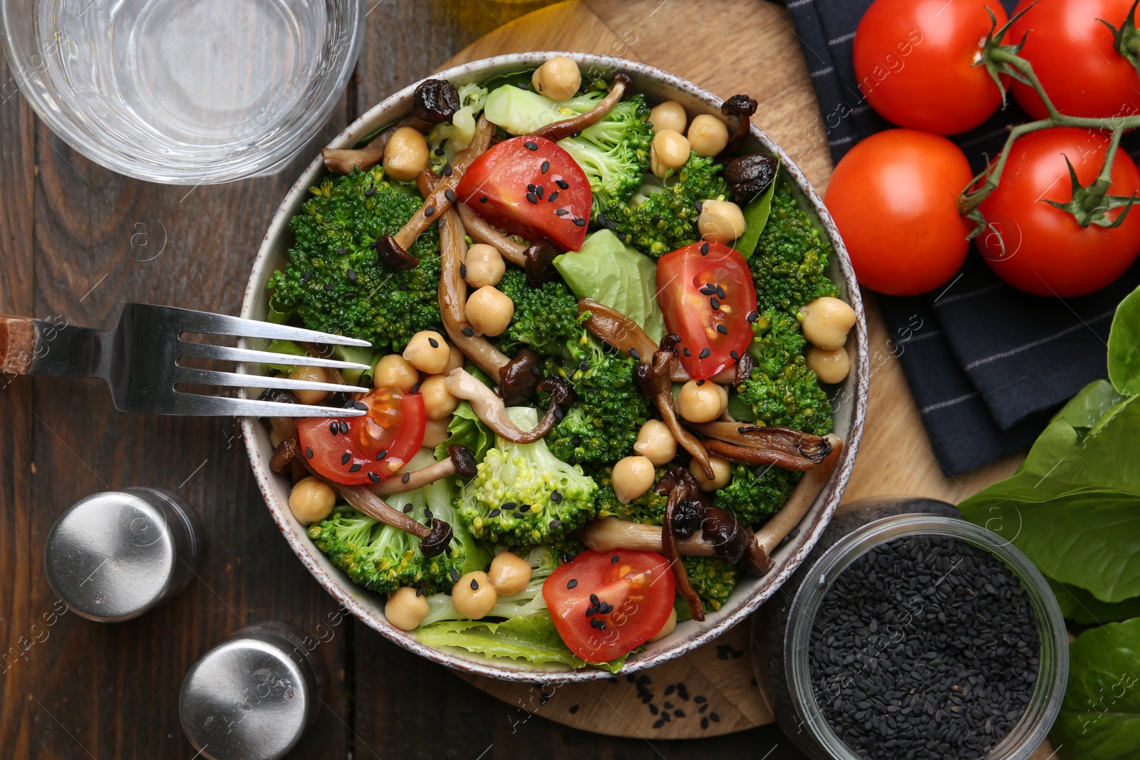 Photo of Delicious salad with shimeji mushrooms served on wooden table, flat lay