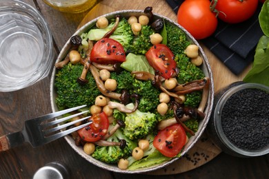 Photo of Delicious salad with shimeji mushrooms served on wooden table, flat lay