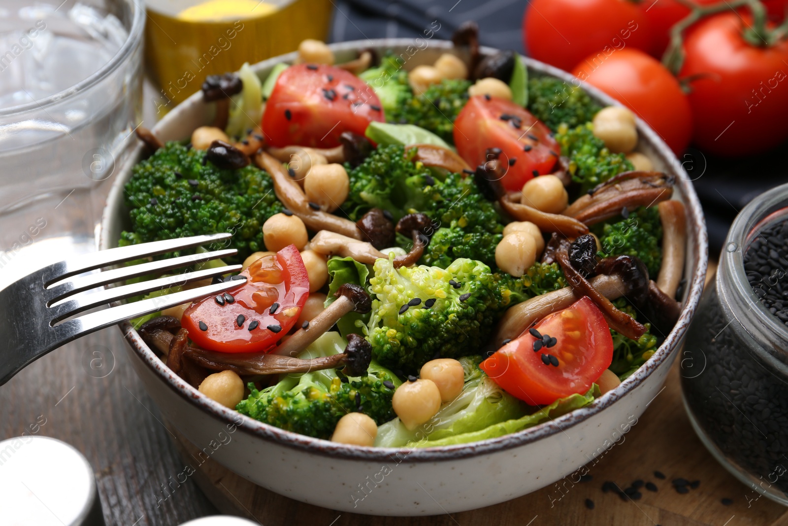 Photo of Delicious salad with shimeji mushrooms served on table, closeup