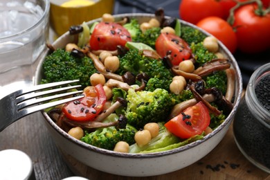 Photo of Delicious salad with shimeji mushrooms served on table, closeup