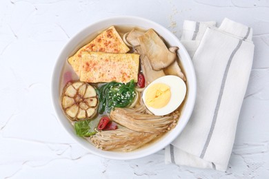 Photo of Tasty ramen with enoki and king oyster (eryngii) mushrooms on white table, top view