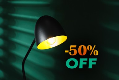 Image of 50 percent discount. Flyer design with glowing lamp in dark room