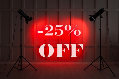 Image of 25 percent discount. Flyer design with red light from spotlights in room
