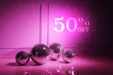 Image of 50 percent discount. Flyer design with sparkling disco balls in room