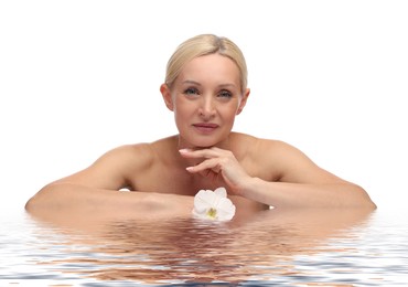Image of Beautiful woman with perfect skin and orchid flower against white background. Her reflection in rippled water