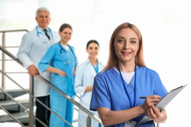 Image of Medical assistant and other healthcare workers in hospital, selective focus