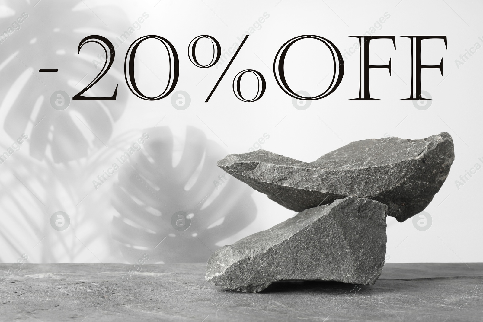 20 percent discount. Flyer design with composition of stones on grey surface Image of 20 percent discount. Flyer design with composition of stones on grey surface
