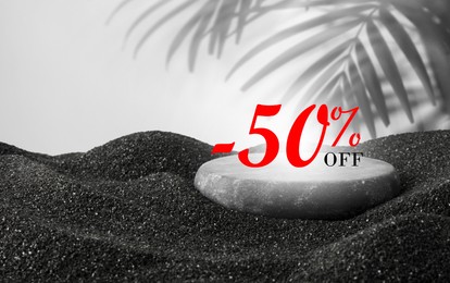 Image of 50 percent discount. Flyer design with pebble on black sand