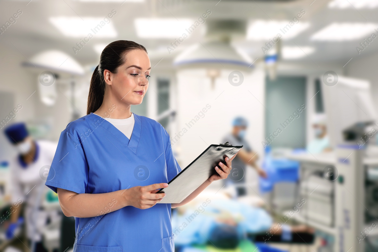 Medical assistant in surgery room. Healthcare worker Image of Medical assistant in surgery room. Healthcare worker