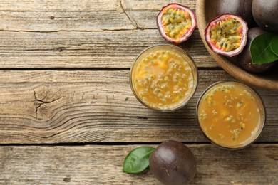 Photo of Tasty passion fruit drink and fresh fruits on wooden table, flat lay. Space for text