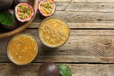 Photo of Tasty passion fruit drink and fresh fruits on wooden table, flat lay. Space for text