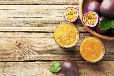 Photo of Tasty passion fruit drink and fresh fruits on wooden table, flat lay. Space for text