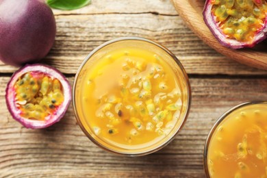 Photo of Tasty passion fruit drink and fresh fruits on wooden table, flat lay