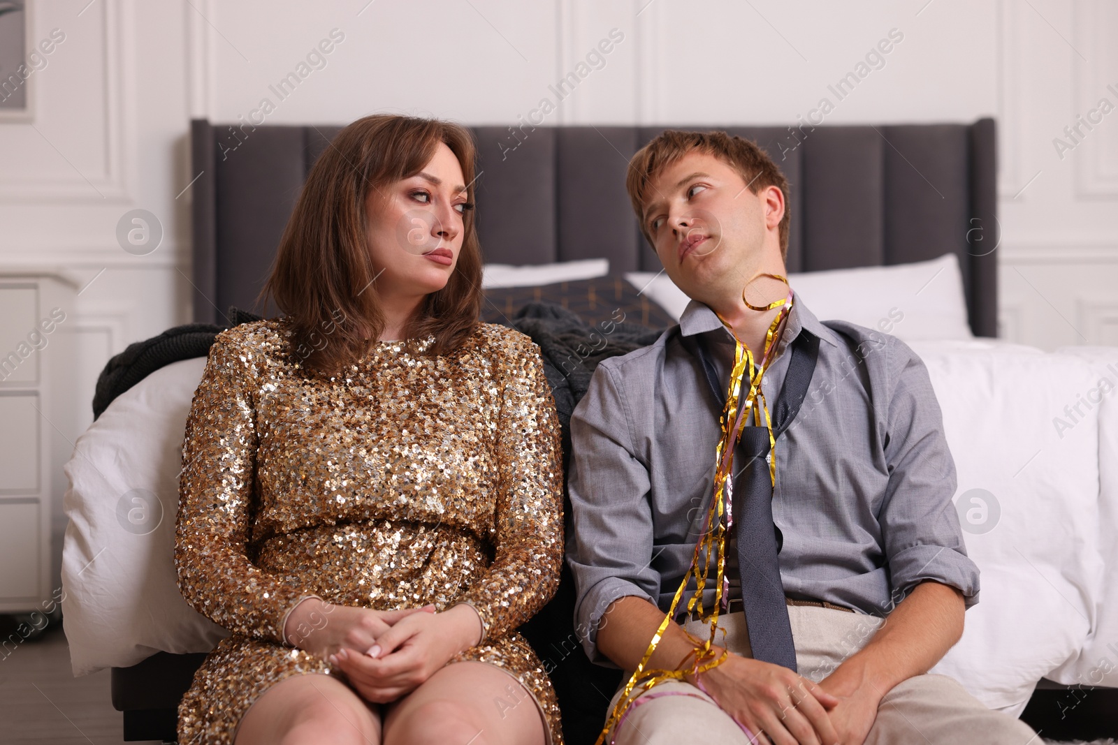 People suffering from hangover near bed indoors Photo of People suffering from hangover near bed indoors
