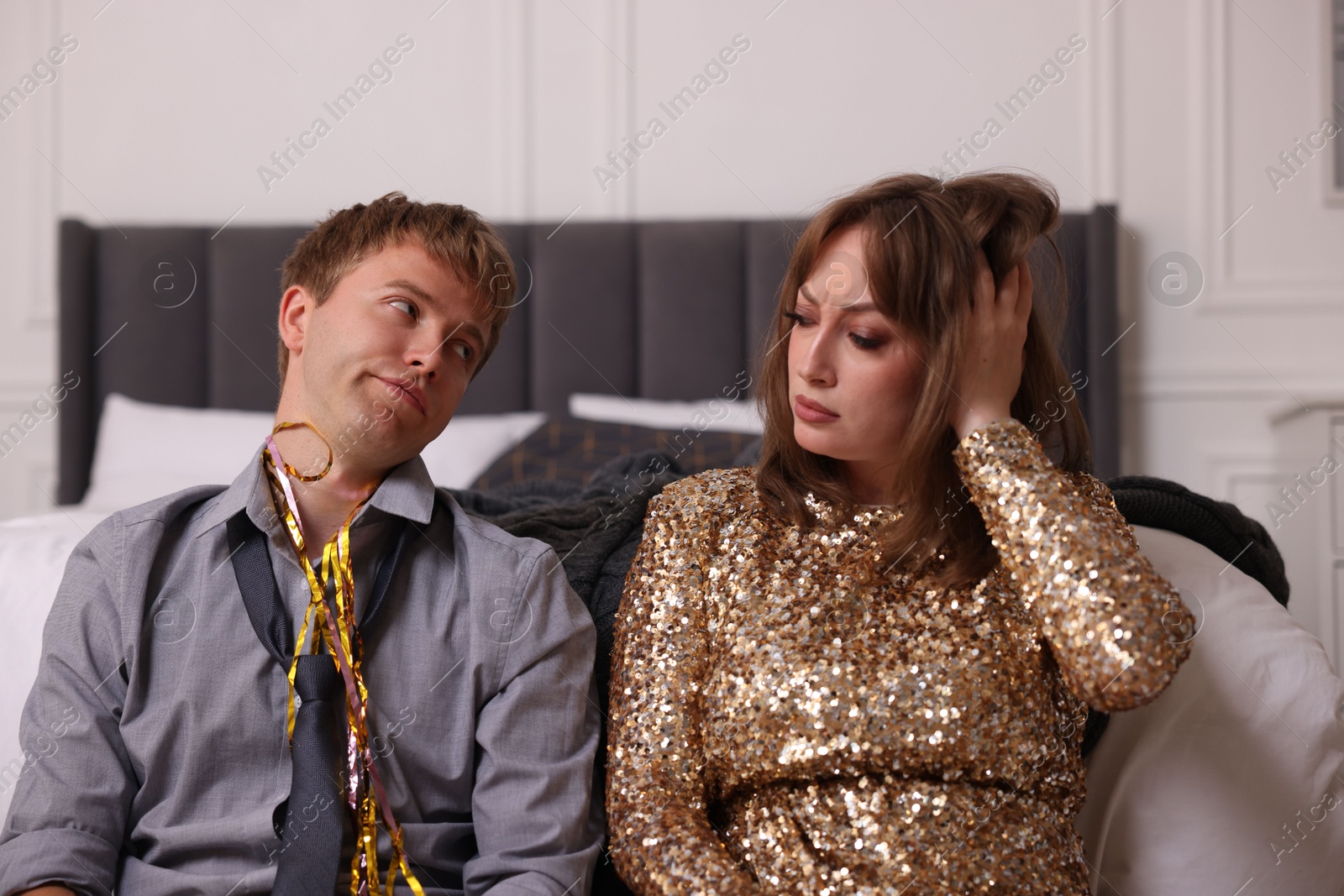 People suffering from hangover near bed indoors Photo of People suffering from hangover near bed indoors
