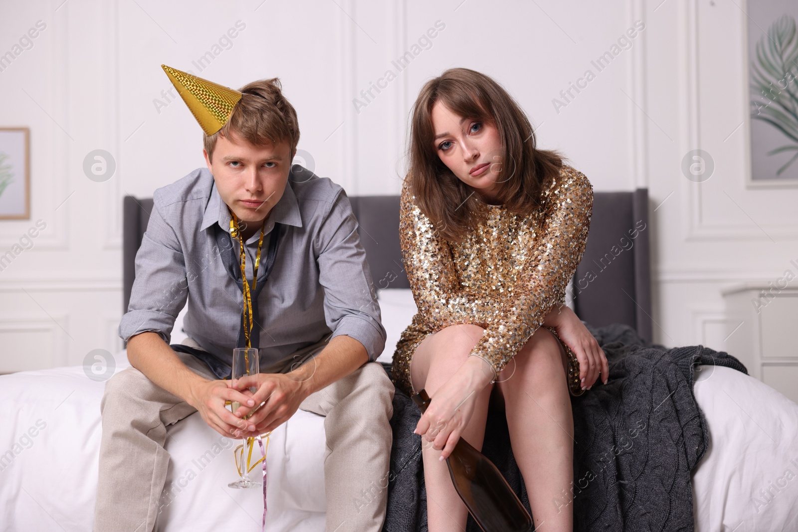 People with alcohol suffering from hangover on bed indoors Photo of People with alcohol suffering from hangover on bed indoors