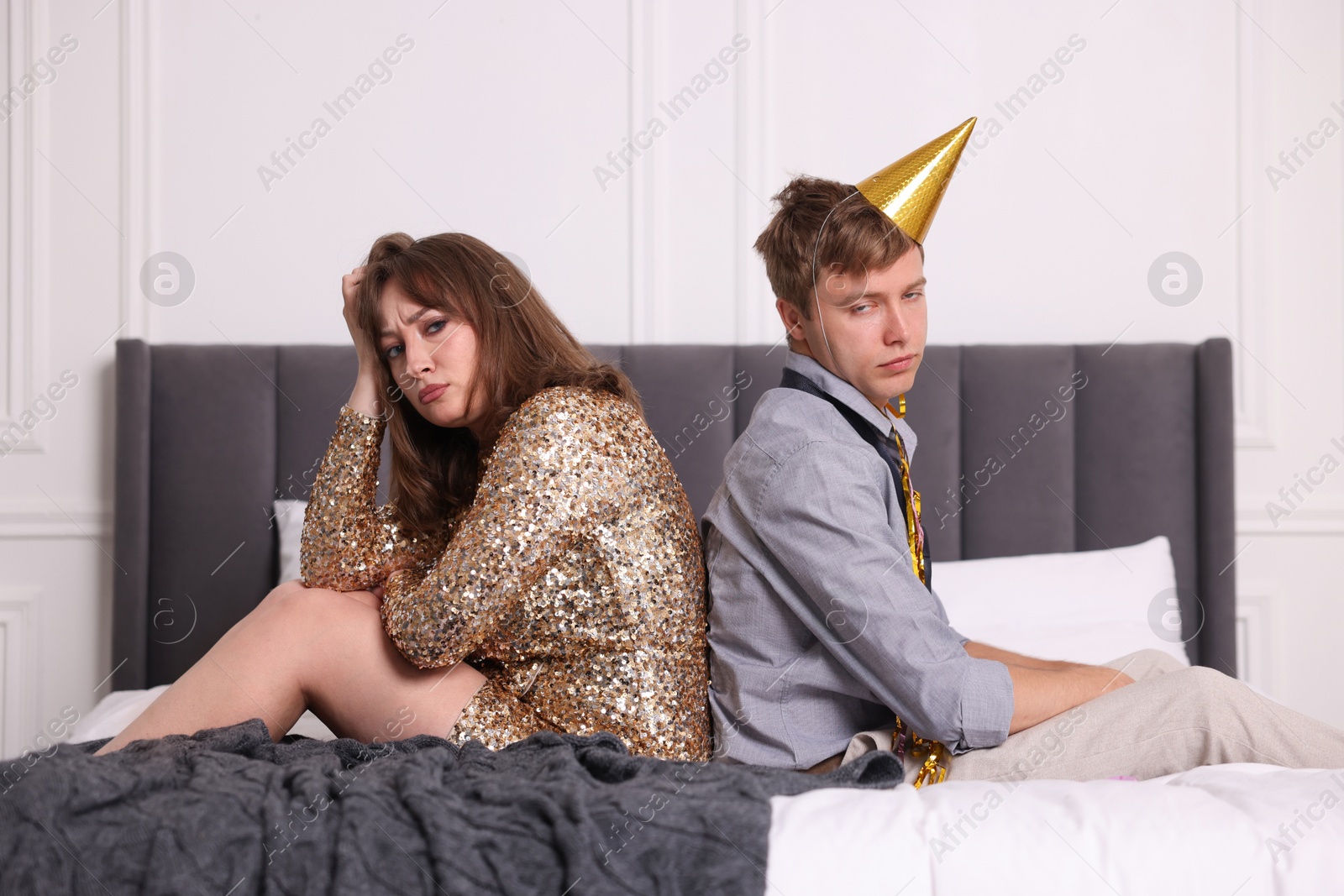 People suffering from hangover on bed indoors Photo of People suffering from hangover on bed indoors