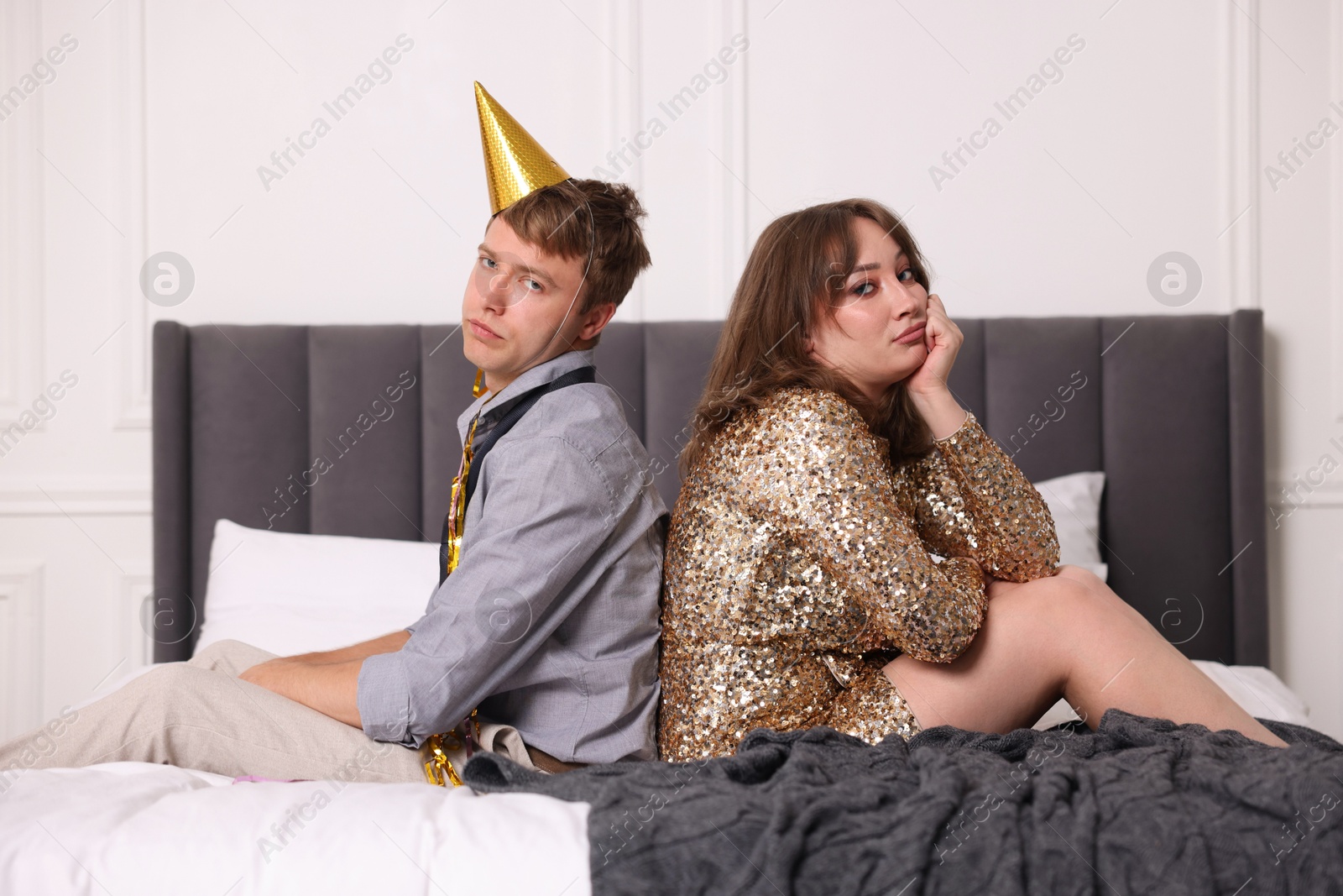 People suffering from hangover on bed indoors Photo of People suffering from hangover on bed indoors