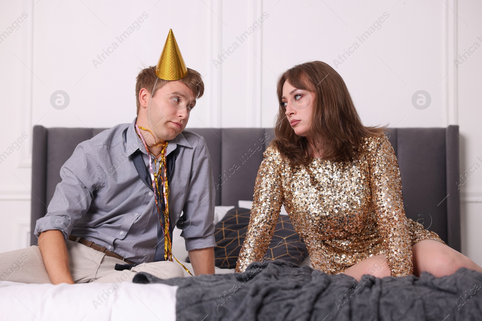 People suffering from hangover on bed indoors Photo of People suffering from hangover on bed indoors