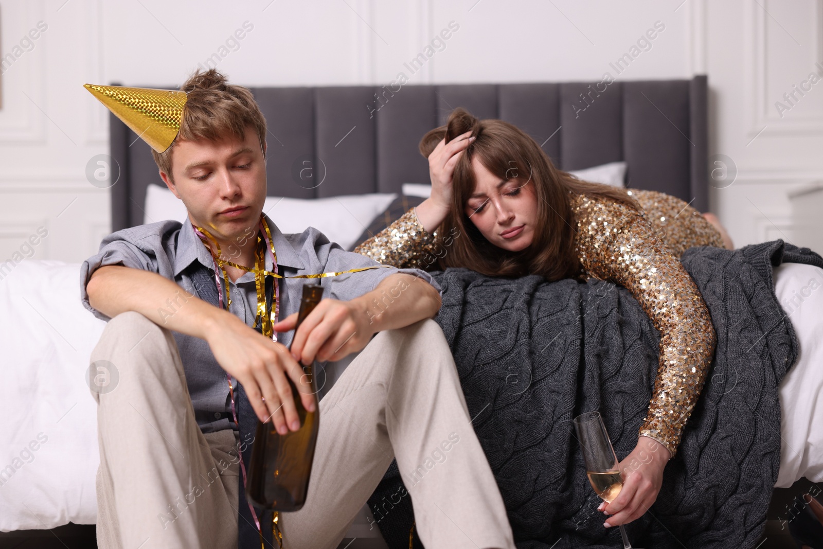 People with alcohol suffering from hangover indoors Photo of People with alcohol suffering from hangover indoors