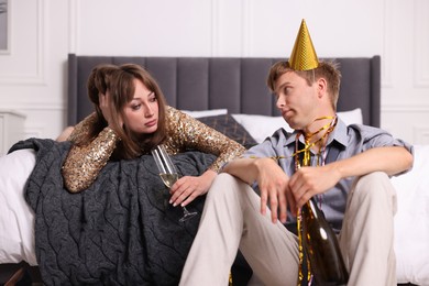 Photo of People with alcohol suffering from hangover indoors