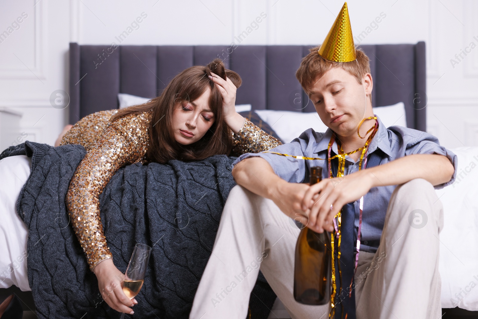 Photo of People with alcohol suffering from hangover indoors