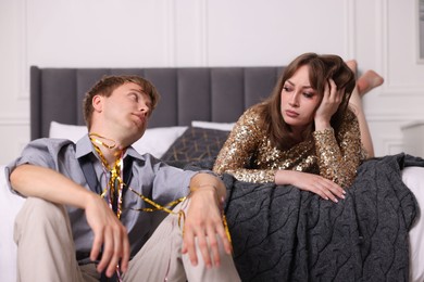 Photo of Unhappy people suffering from hangover at home