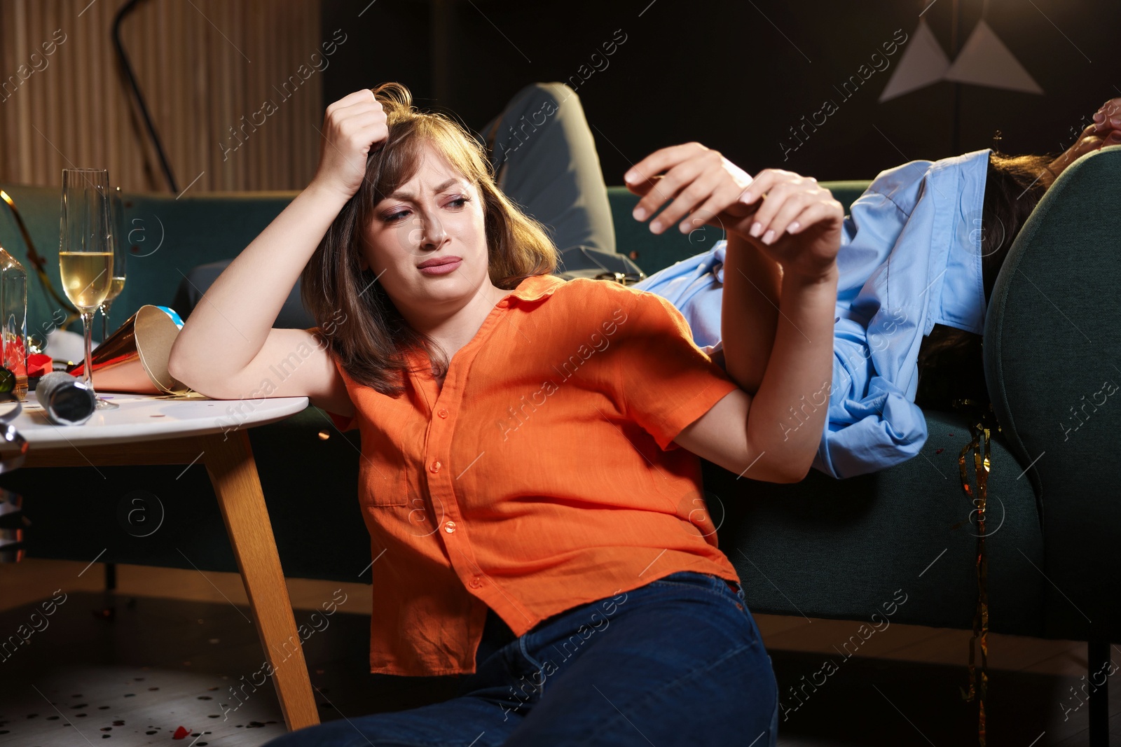 People suffering from hangover in messy room after party Photo of People suffering from hangover in messy room after party