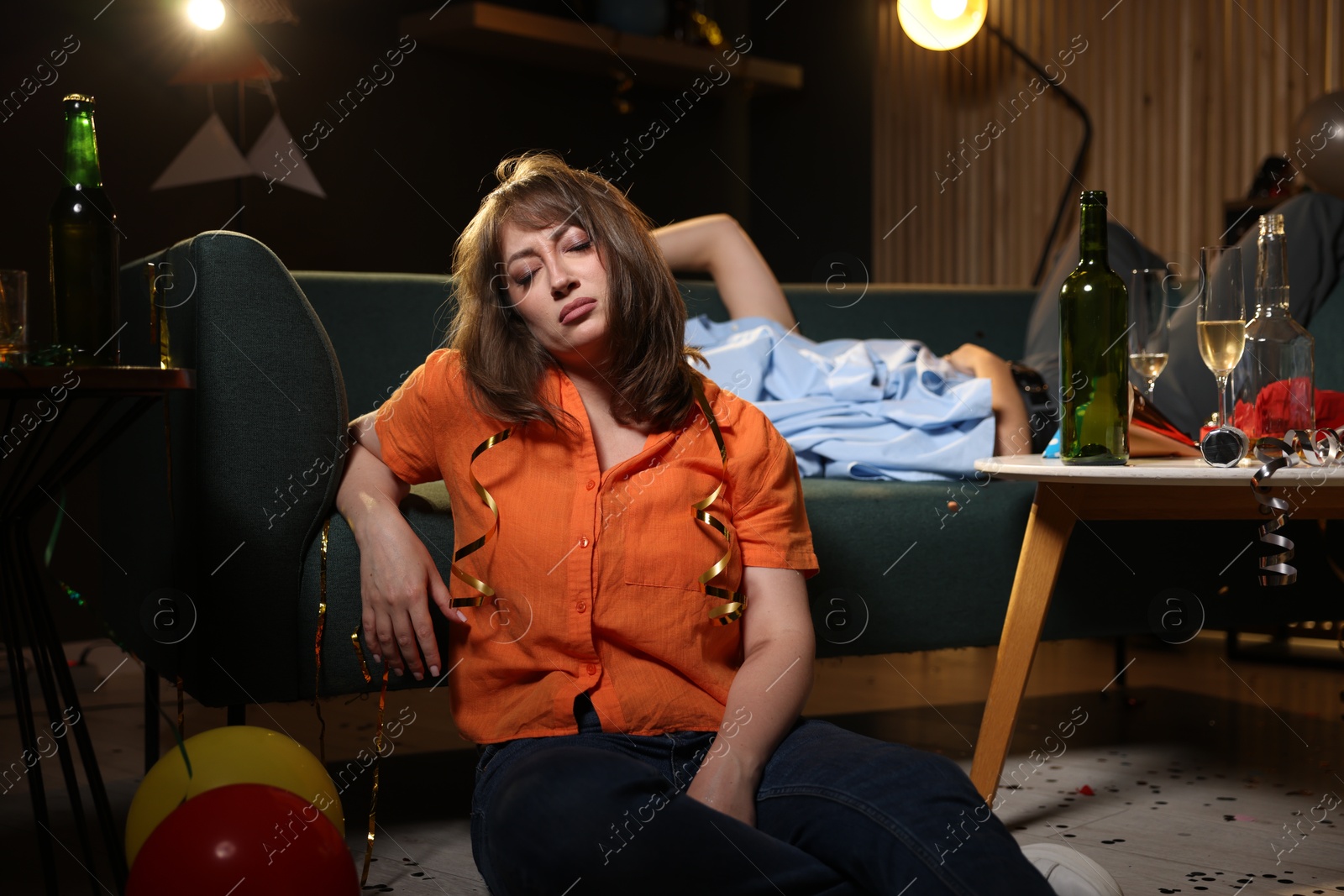People suffering from hangover in messy room after party, selective focus Photo of People suffering from hangover in messy room after party, selective focus