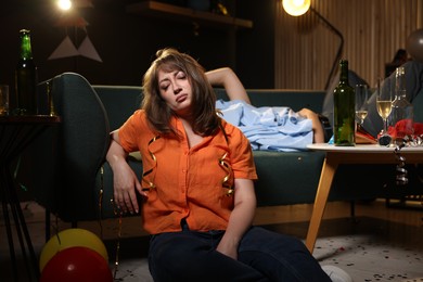Photo of People suffering from hangover in messy room after party, selective focus