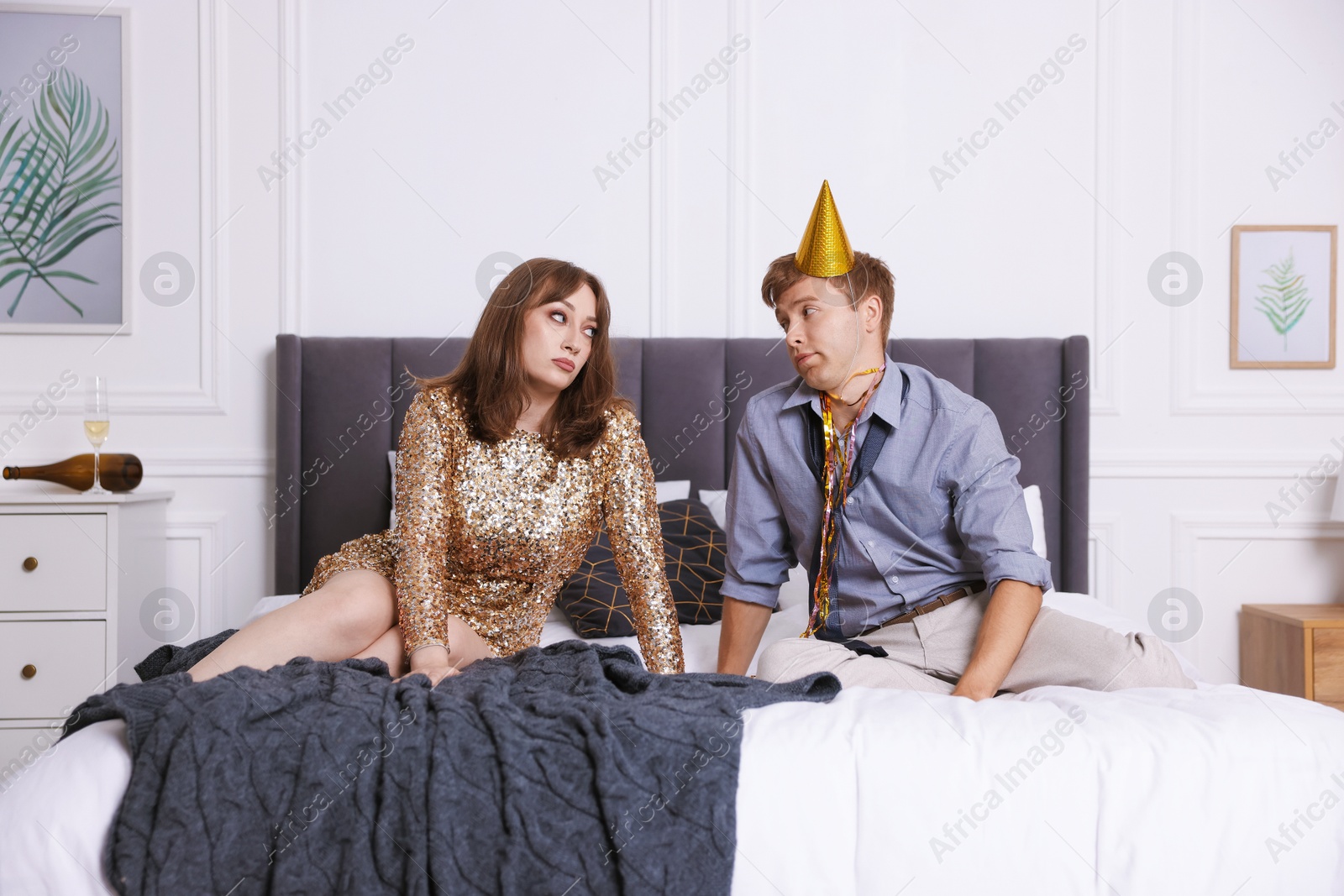 Photo of People suffering from hangover on bed indoors