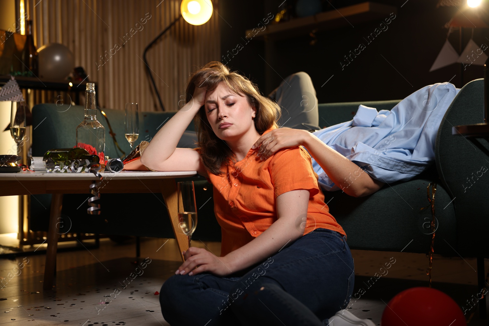 People suffering from hangover in messy room after party Photo of People suffering from hangover in messy room after party