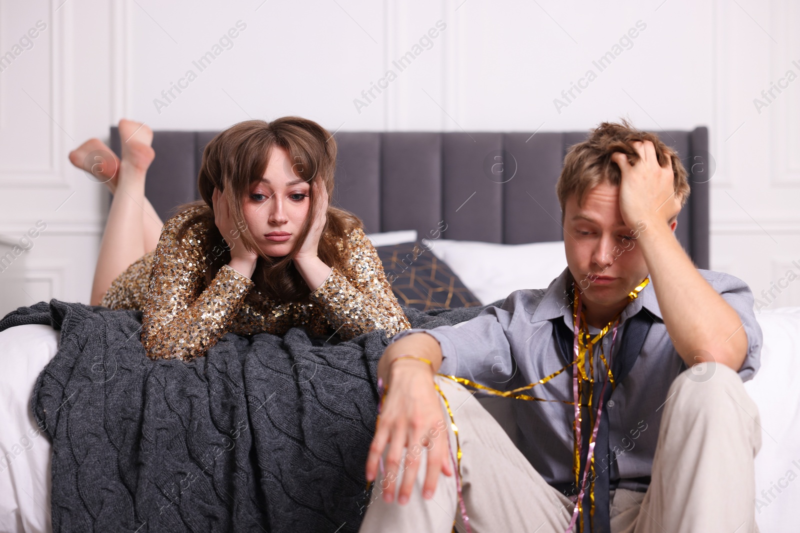 Photo of Unhappy people suffering from hangover at home