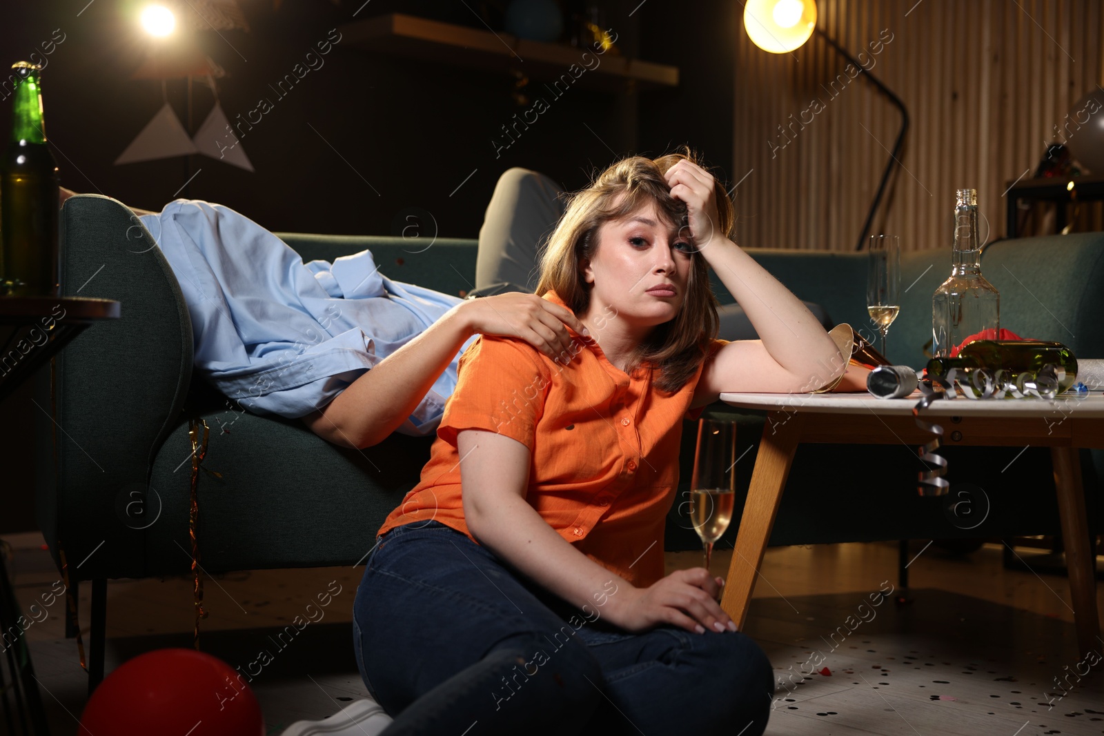 People suffering from hangover in messy room after party Photo of People suffering from hangover in messy room after party