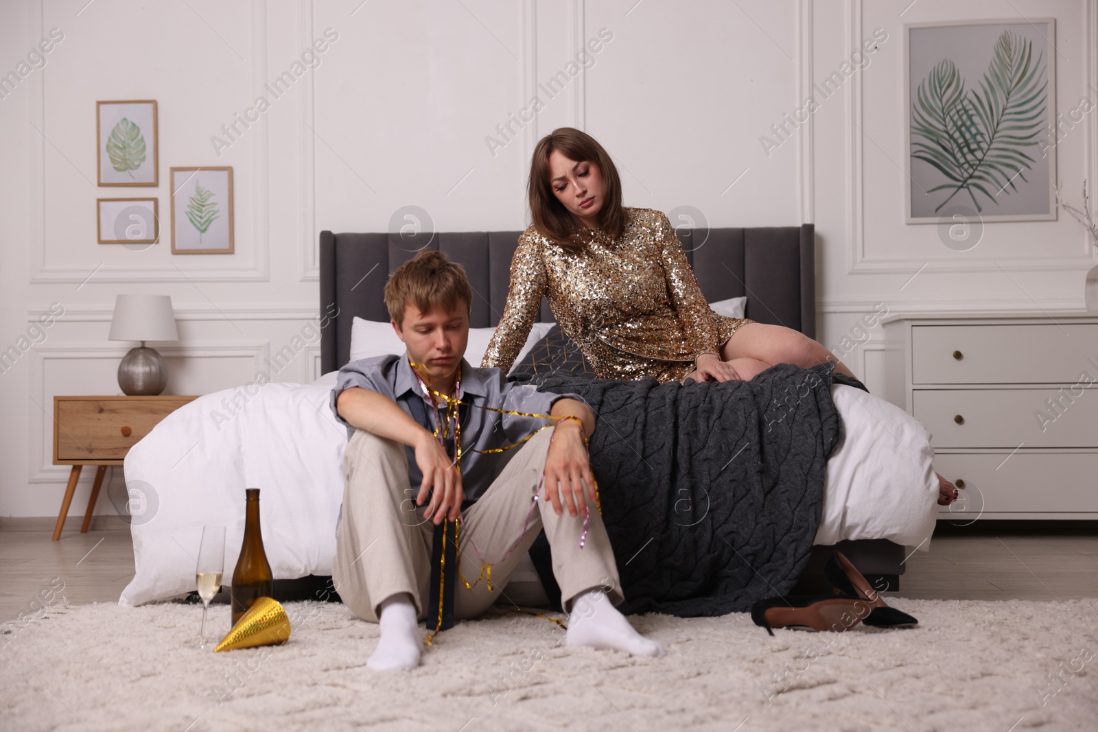 Photo of Unhappy people suffering from hangover at home