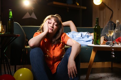 Photo of People suffering from hangover in messy room after party, selective focus