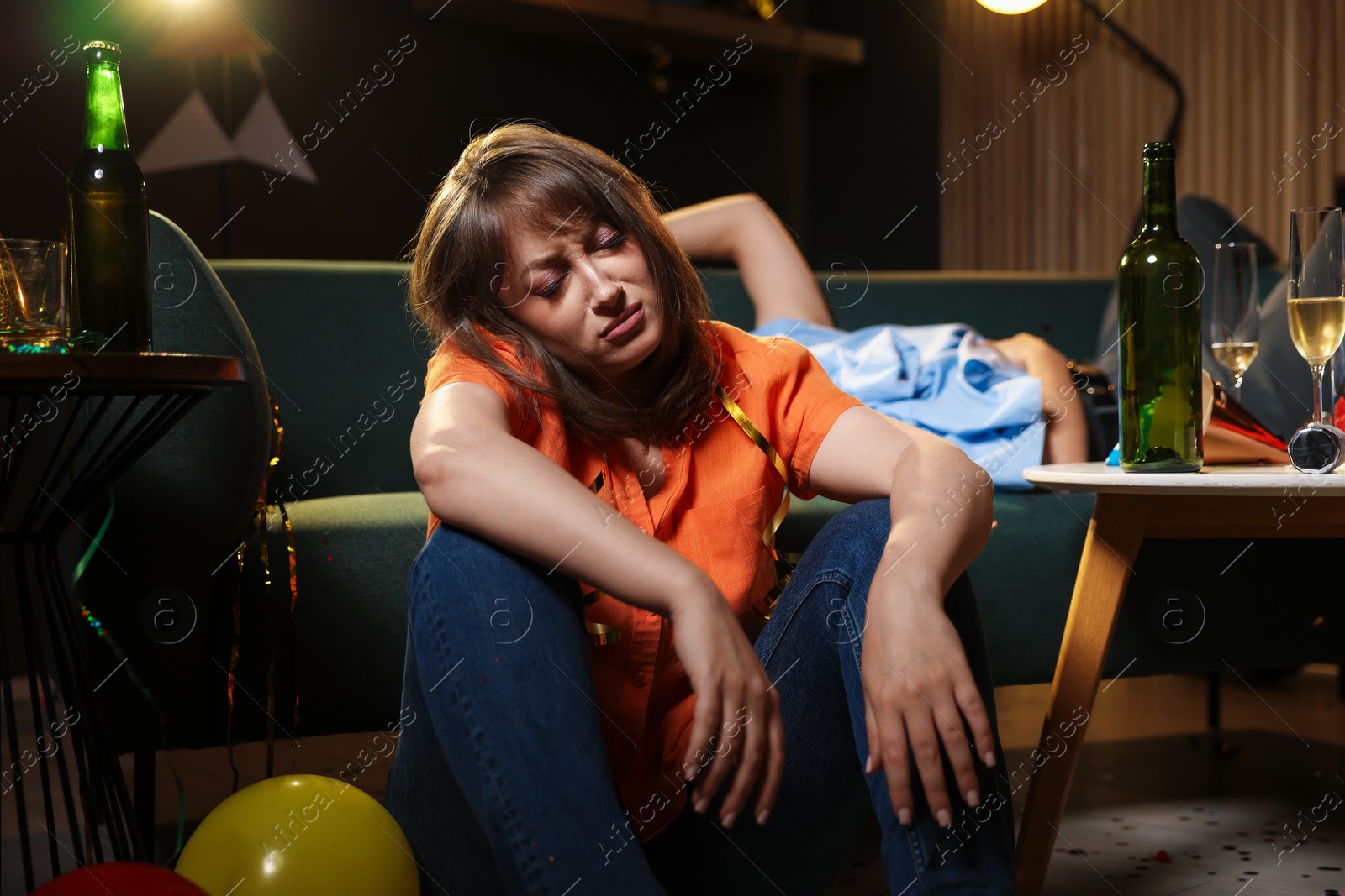 Photo of People suffering from hangover in messy room after party, selective focus