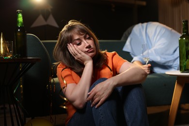 Photo of People suffering from hangover in messy room after party, selective focus