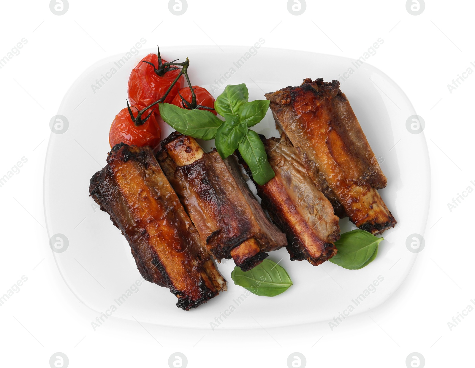 Photo of Roasted beef ribs, tomatoes and basil isolated on white, top view