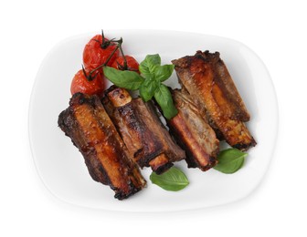 Photo of Roasted beef ribs, tomatoes and basil isolated on white, top view