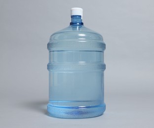 Photo of Cooler bottle with water on grey background, closeup