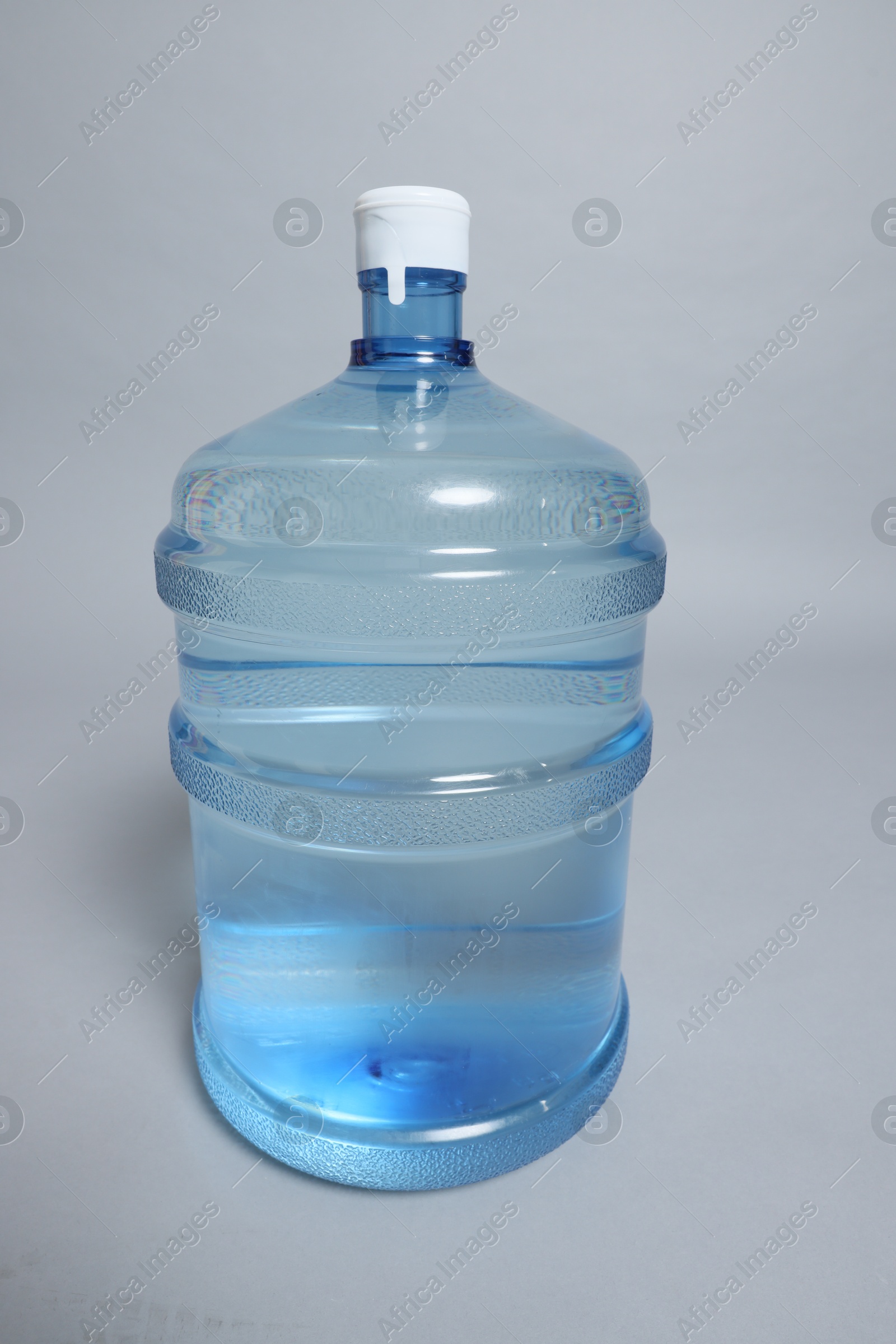 Photo of Cooler bottle with water on grey background