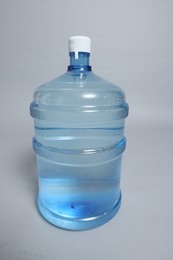 Photo of Cooler bottle with water on grey background