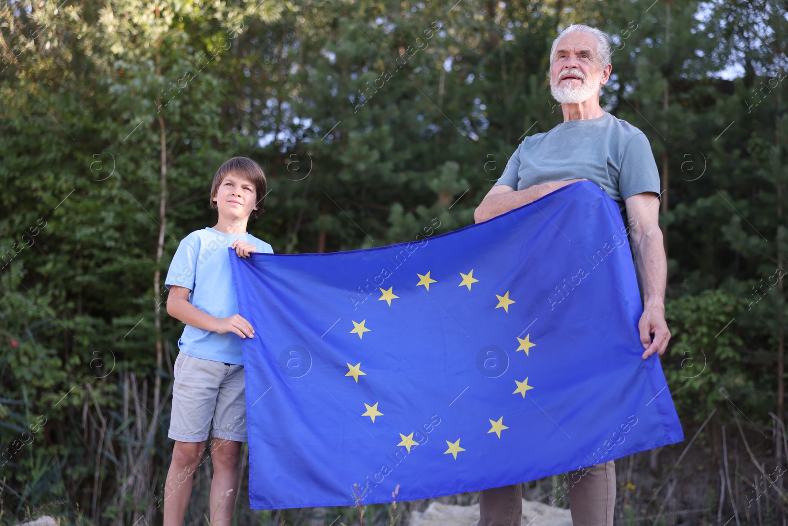 Photo of Grandfather and his nephew with flag of European Union outdoors
