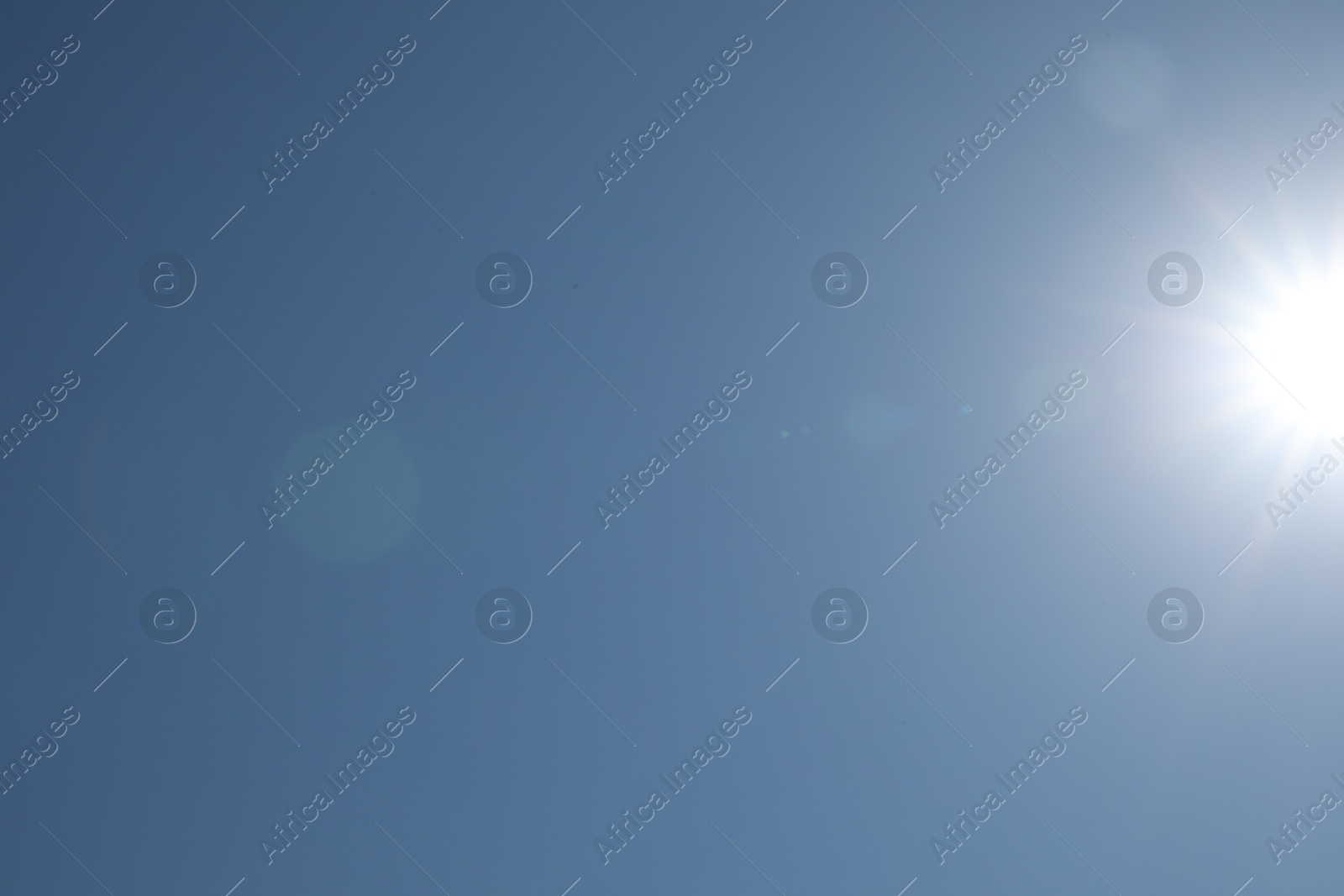 Photo of Beautiful blue sky on sunny day, bottom view