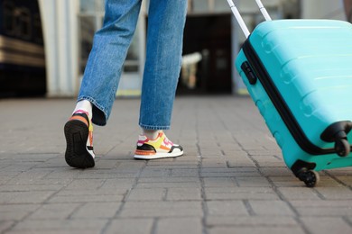 Photo of Goodbye. Woman with luggage on platform of railway station, closeup